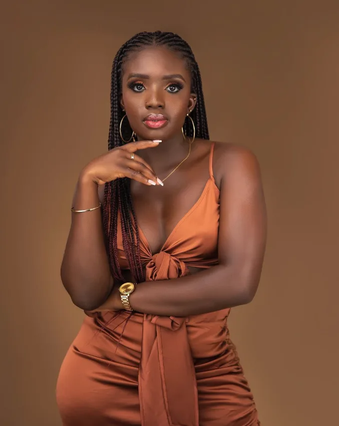 DJ Akuaa in an orange satin dress portrait